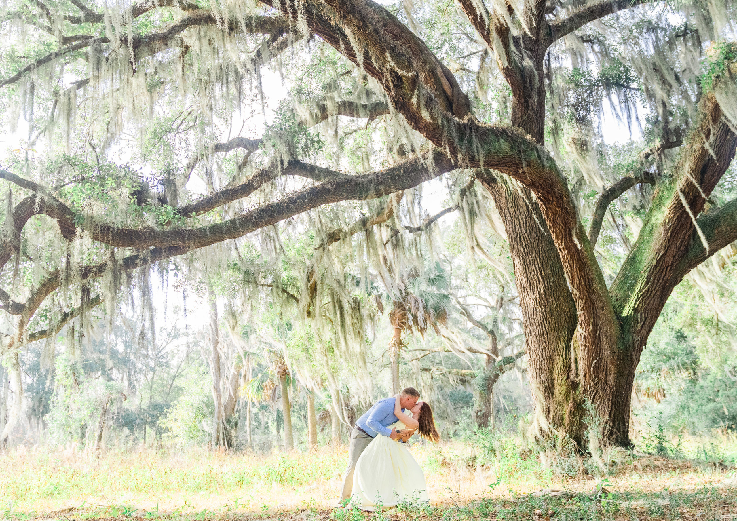 engagement photo under spanish moss in an oak tree at The Bluff Venue in Kingsland Georgia