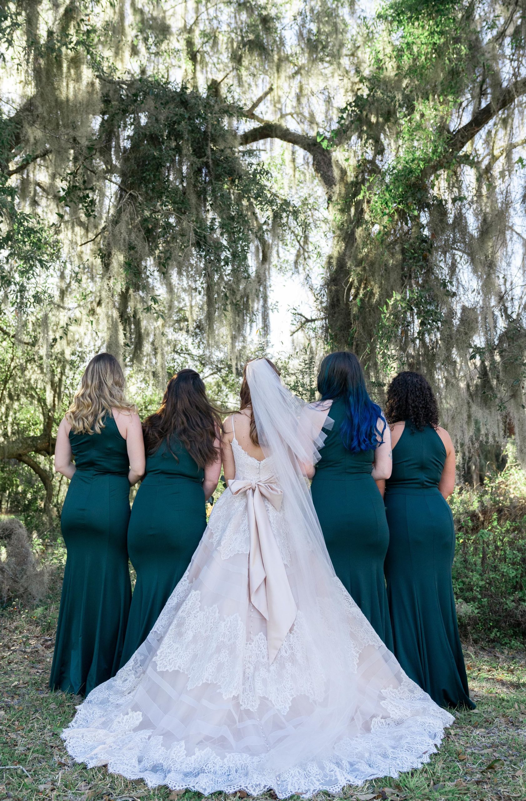 bridal party standing under spanish moss oak trees in kingsland georgia at the bluff venue