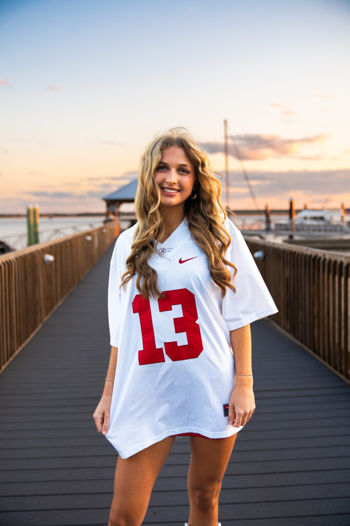 sunset senior portraits in downtown st marys waterfront on a pier