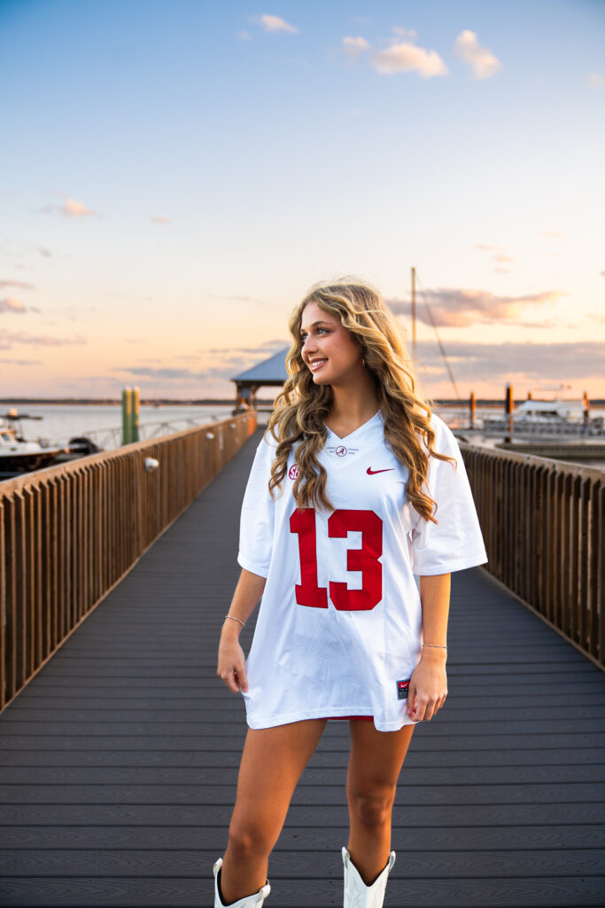 sunset senior portraits in downtown st marys waterfront on a pier