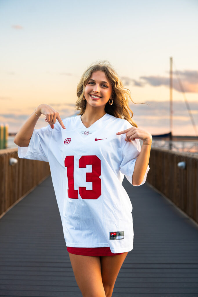 sunset senior portraits in downtown st marys waterfront on a pier