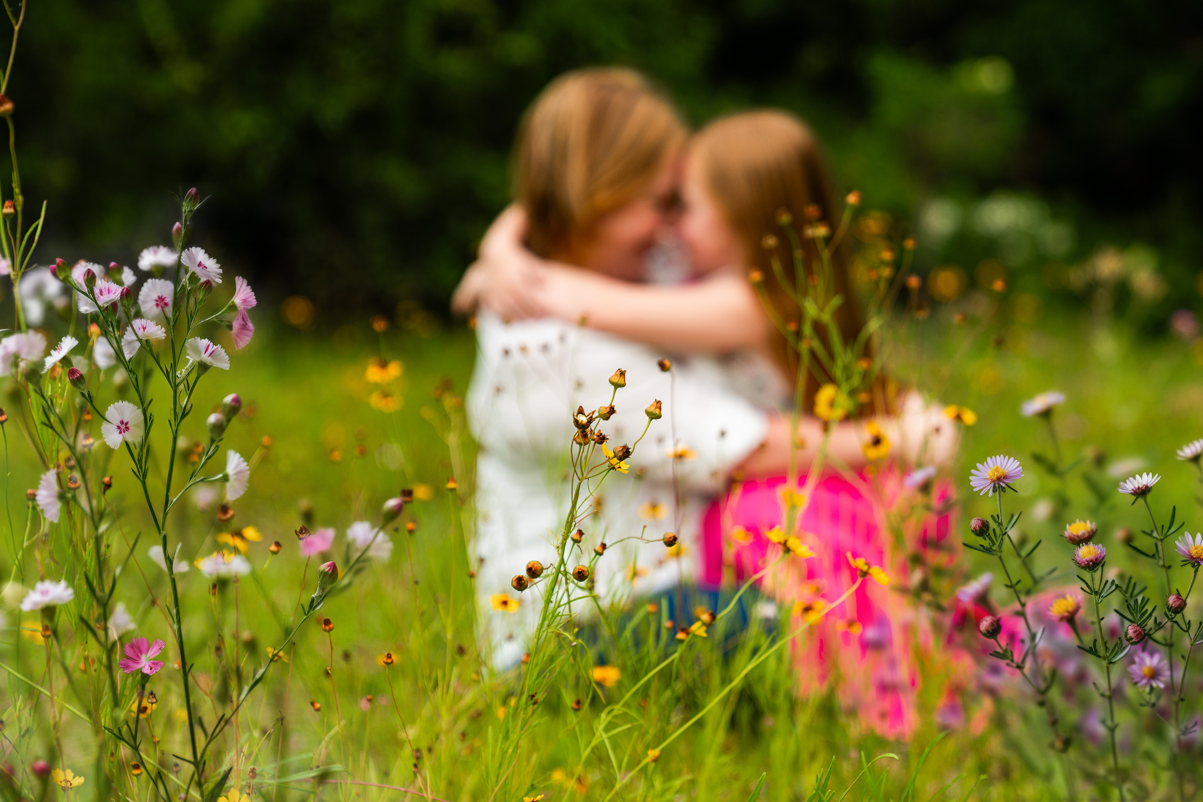 Yulee Florida family photographer with mom and kids playing in a wildflower field